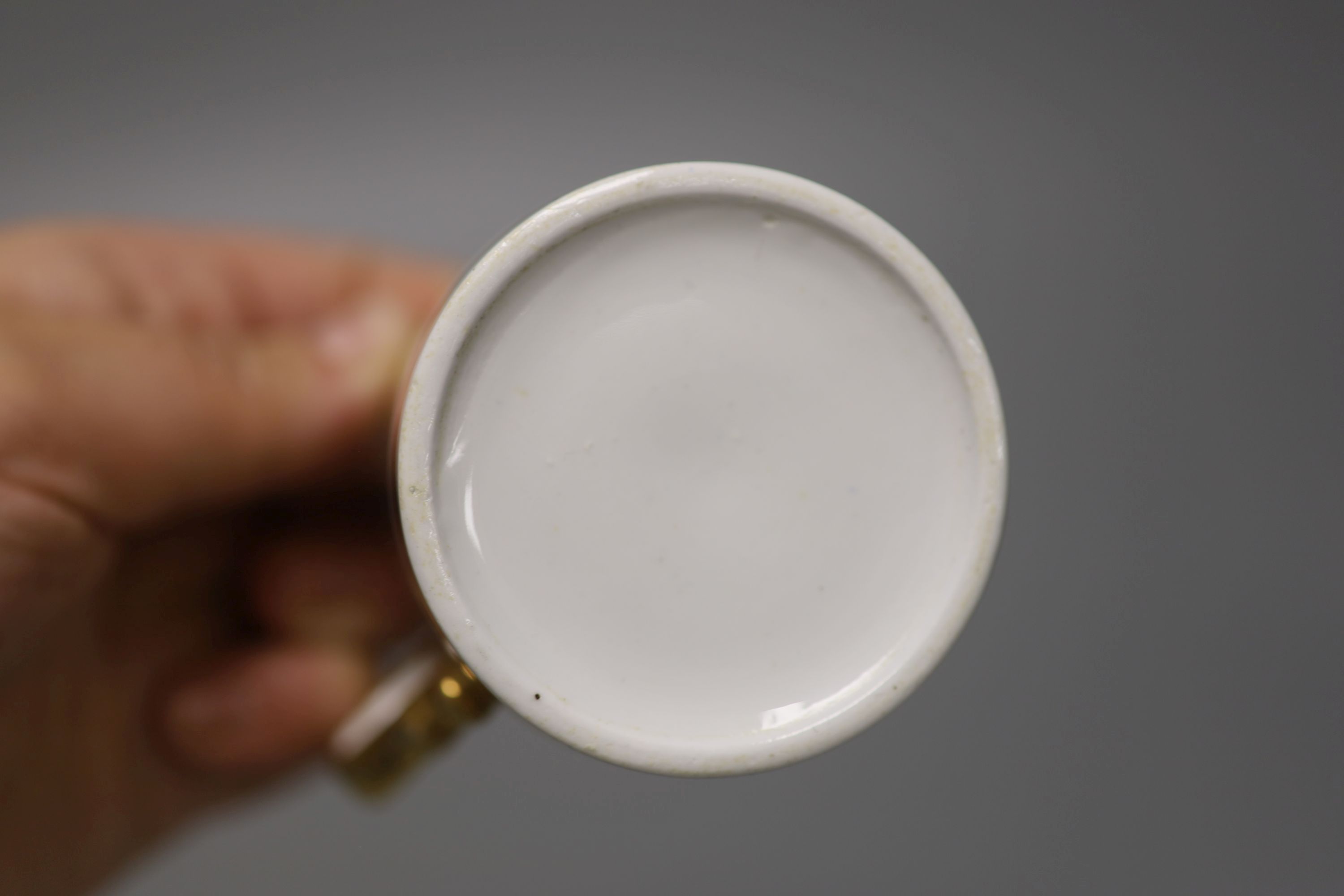 A Spode fine cup and saucer decorated with raised gilding in neo-classical style pattern Spode 4327 in red,